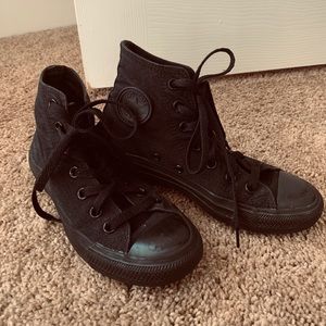 Solid black converse, gently worn